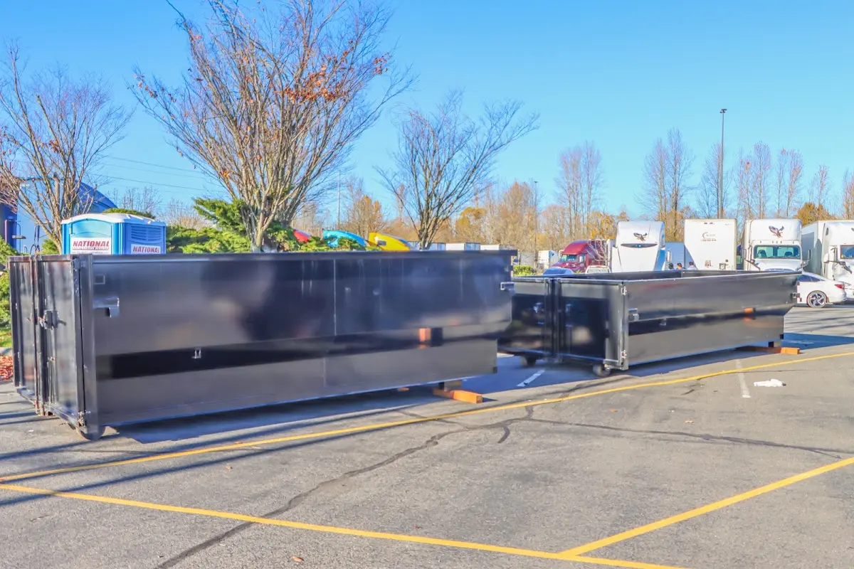 Professional dumpster rental service with roll-off container on residential driveway in Channelview